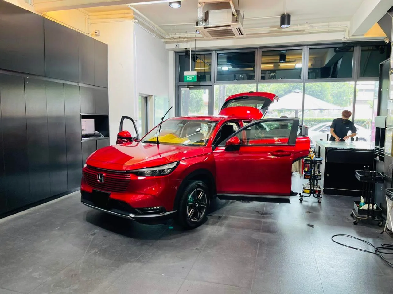Red Honda SUV during window film installation at Infratint Singapore