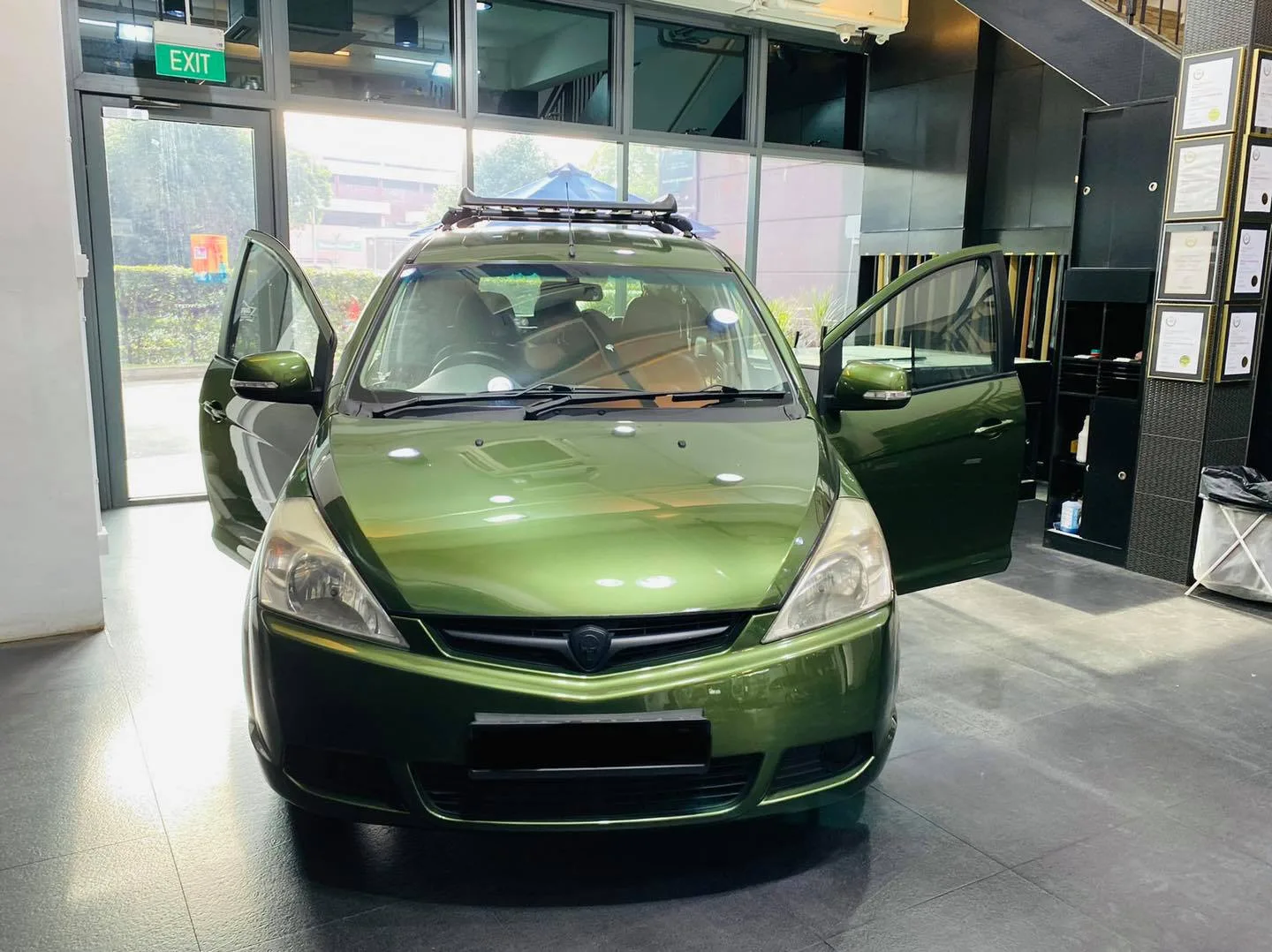 Green Honda MPV with doors open at Infratint Singapore for window film
