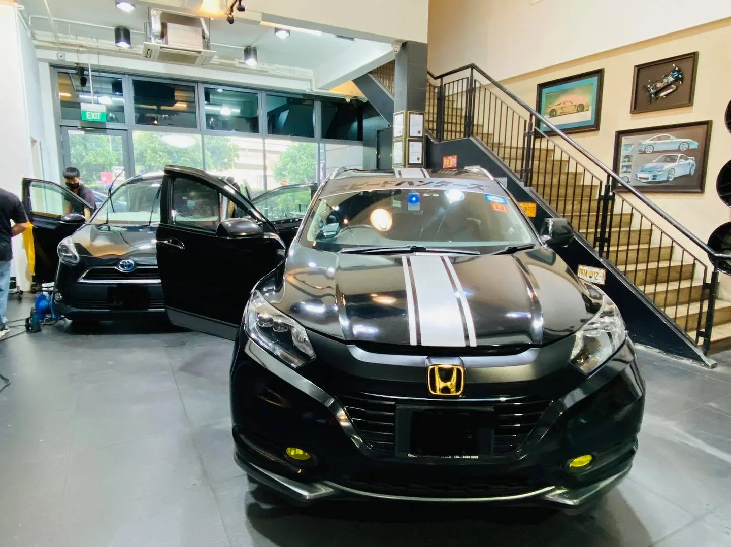 Black Honda HR-V and silver Subaru inside the Infratint Singapore showroom