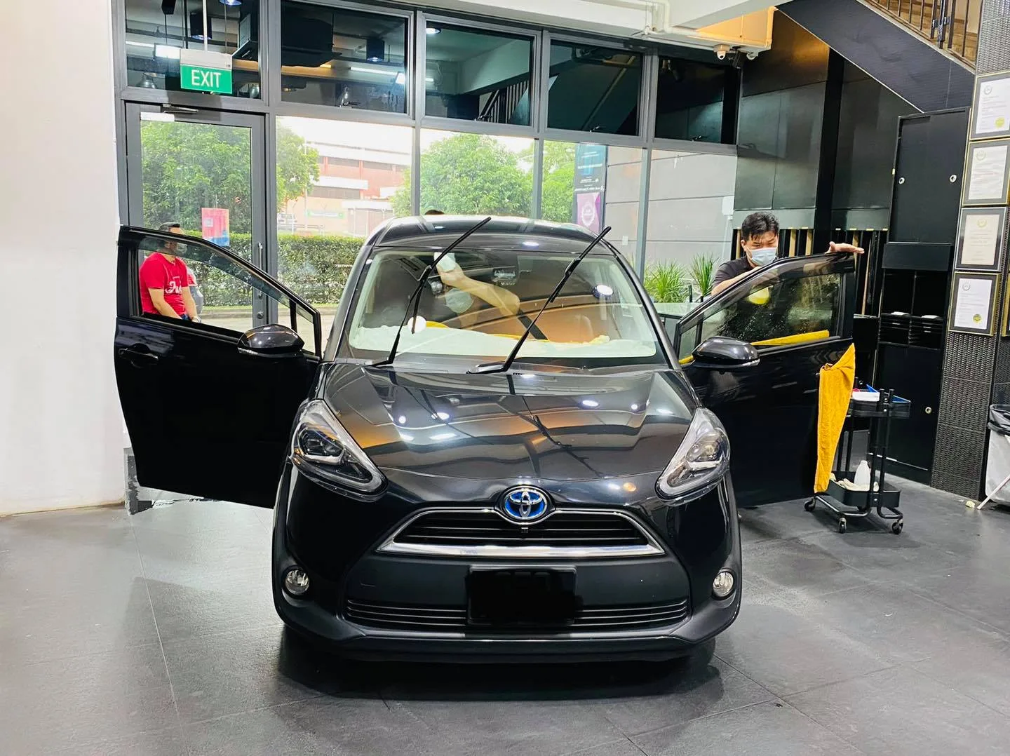Black Toyota Sienta during window film install at Infratint Singapore