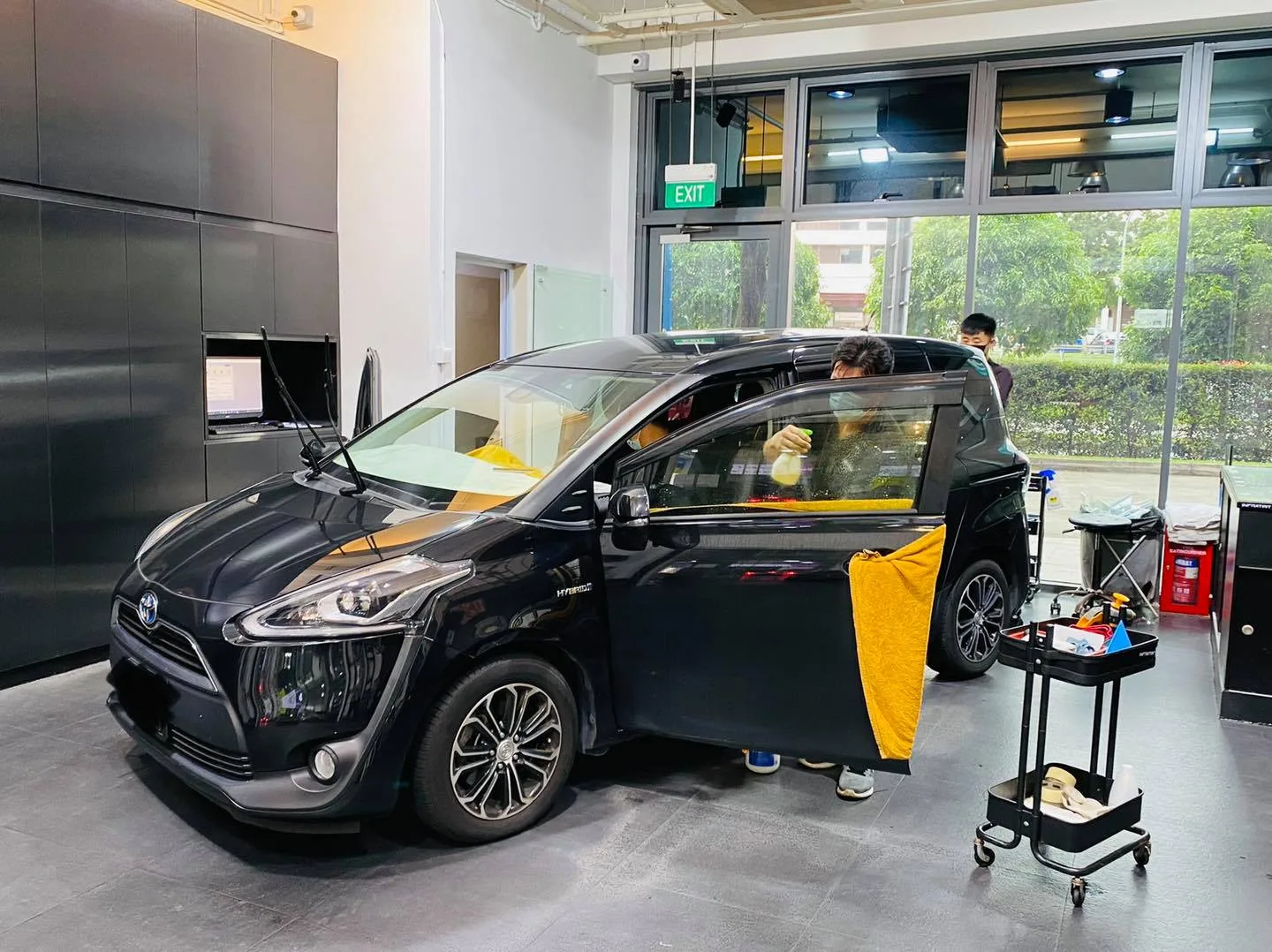 Black Toyota Sienta side view during window tinting at Infratint Singapore