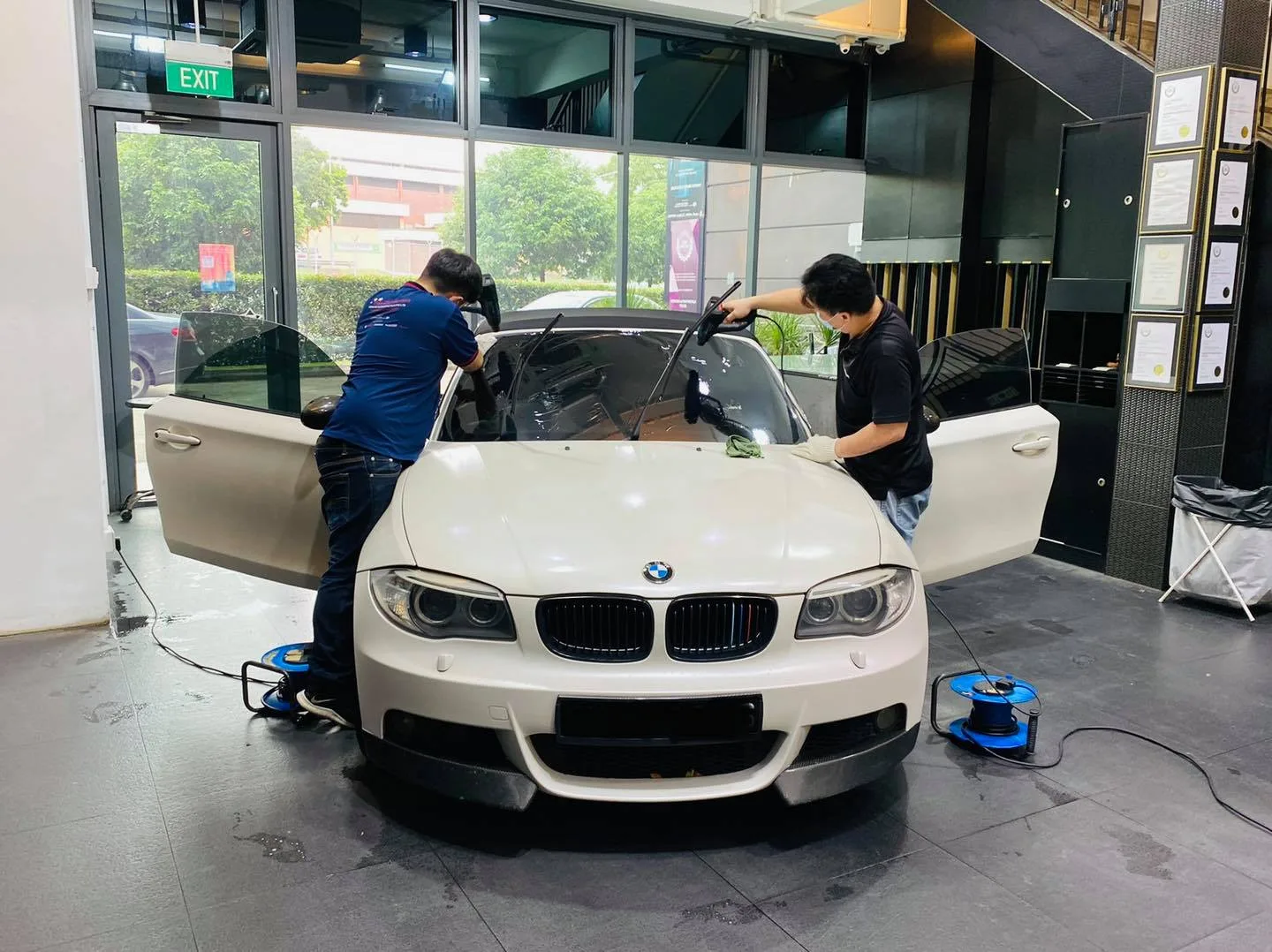 White BMW coupe front view during window tinting at Infratint Singapore