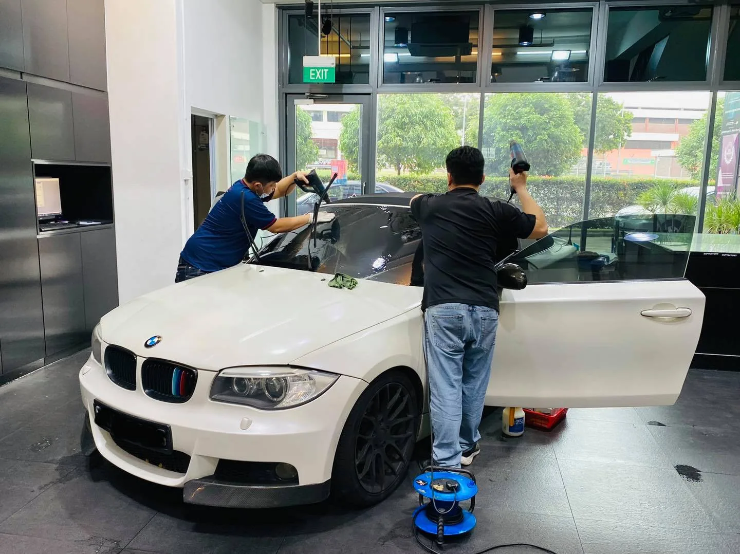 White BMW coupe during window film install at Infratint Singapore
