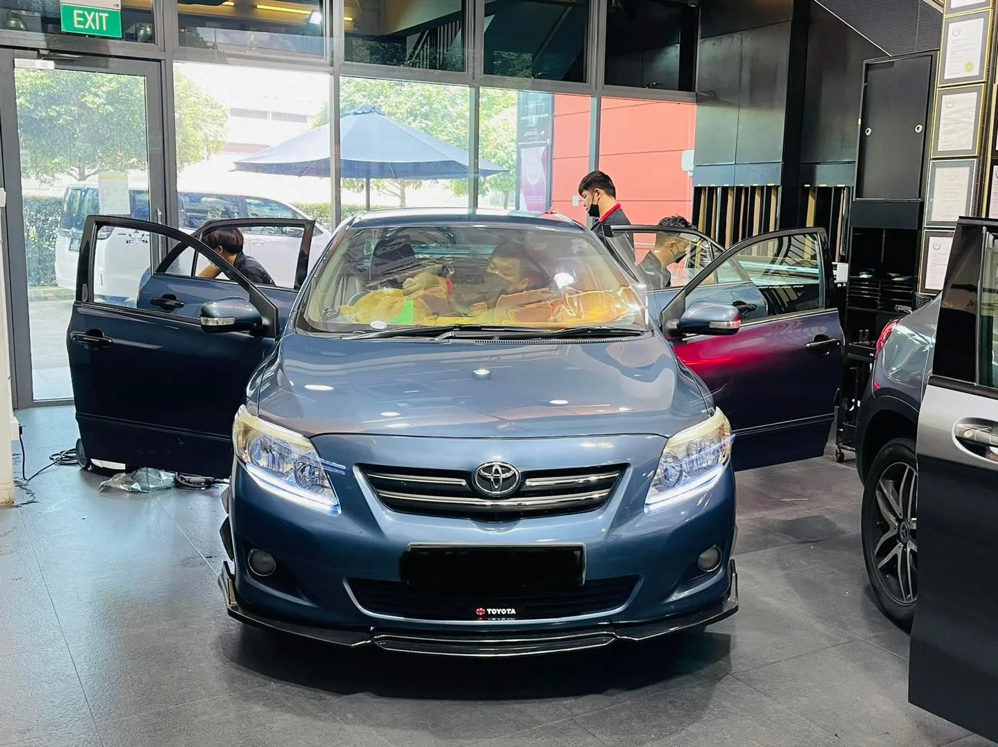 Blue Toyota Corolla Altis in for window film installation at Infratint Singapore