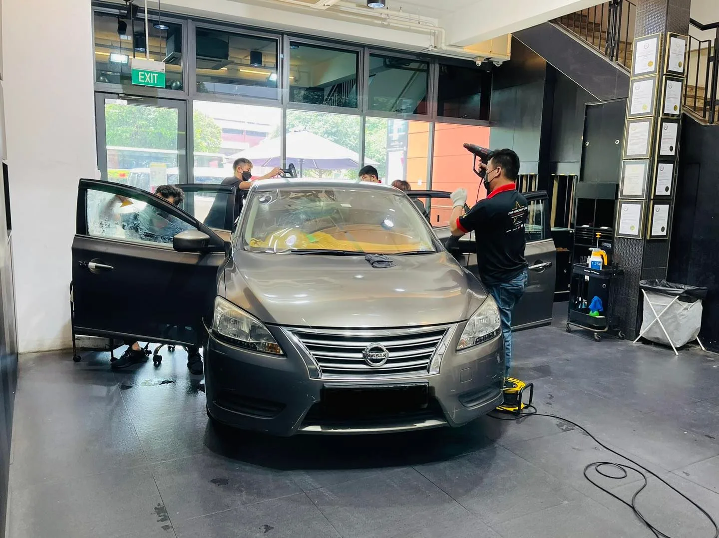 Grey Nissan Sylphy being prepped for window film at Infratint Singapore