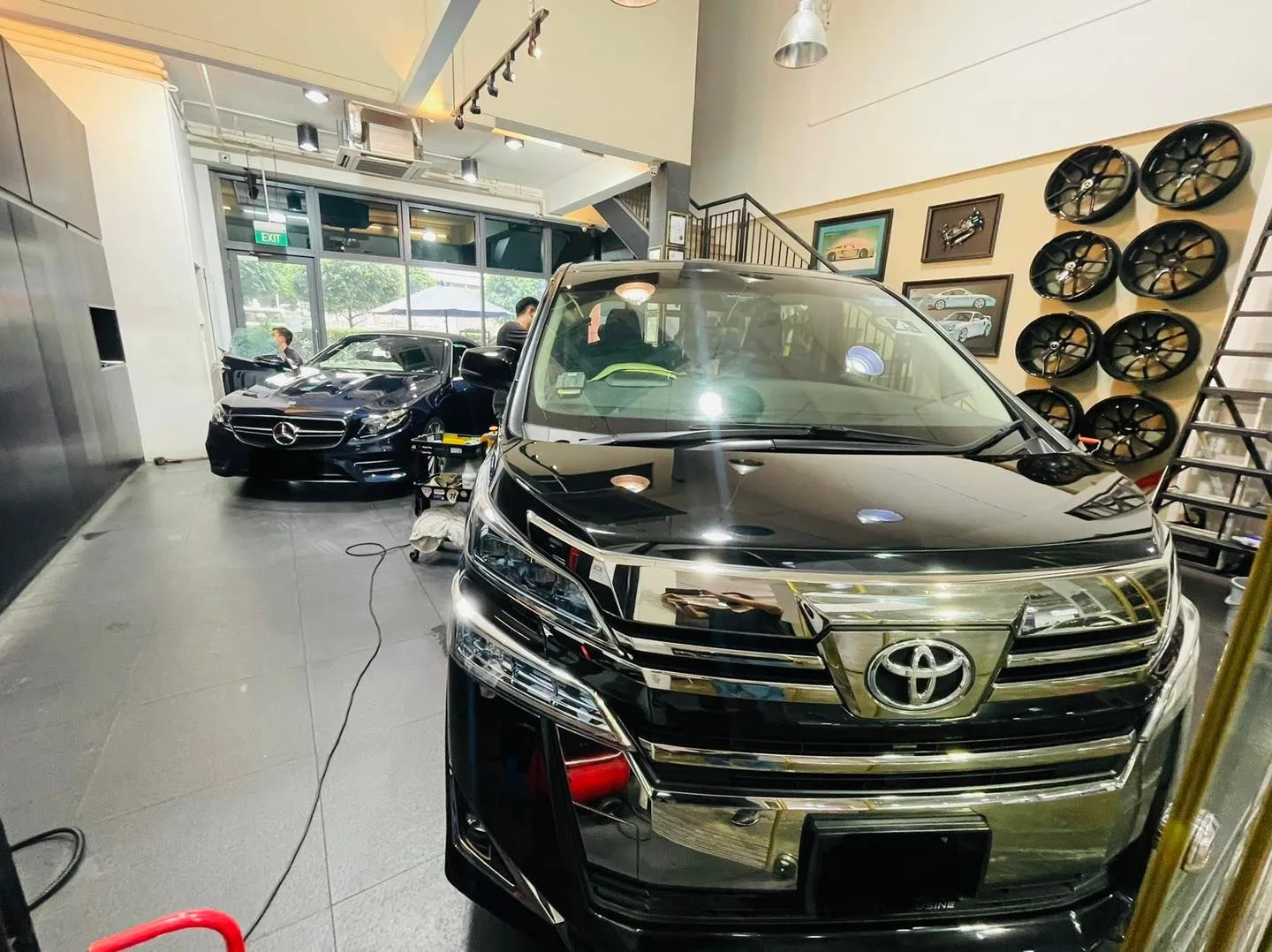 Black Toyota Vellfire MPV and Mercedes sedan inside Infratint Singapore
