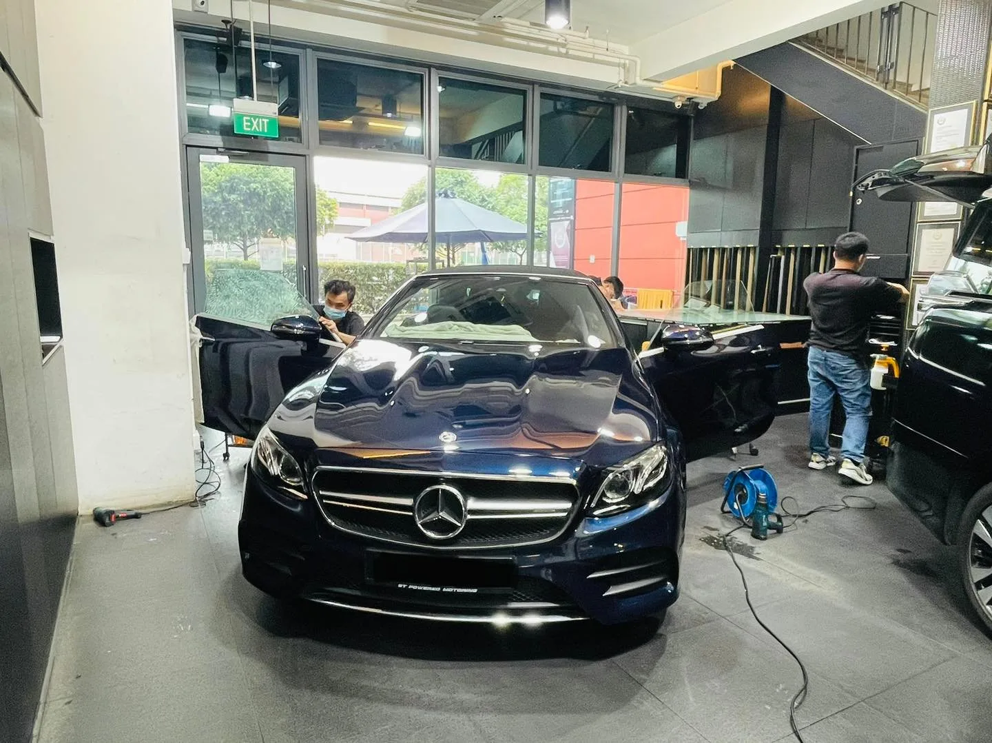 Dark blue Mercedes-Benz E-Class sedan being tinted at Infratint Singapore
