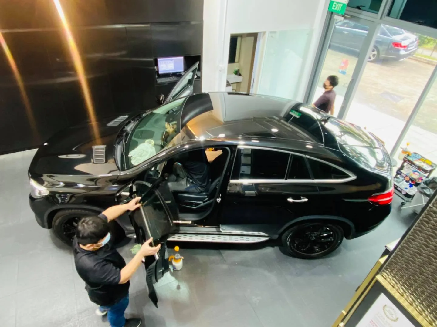 Overhead view of a black Mercedes-Benz GLE Coupe being tinted at Infratint Singapore