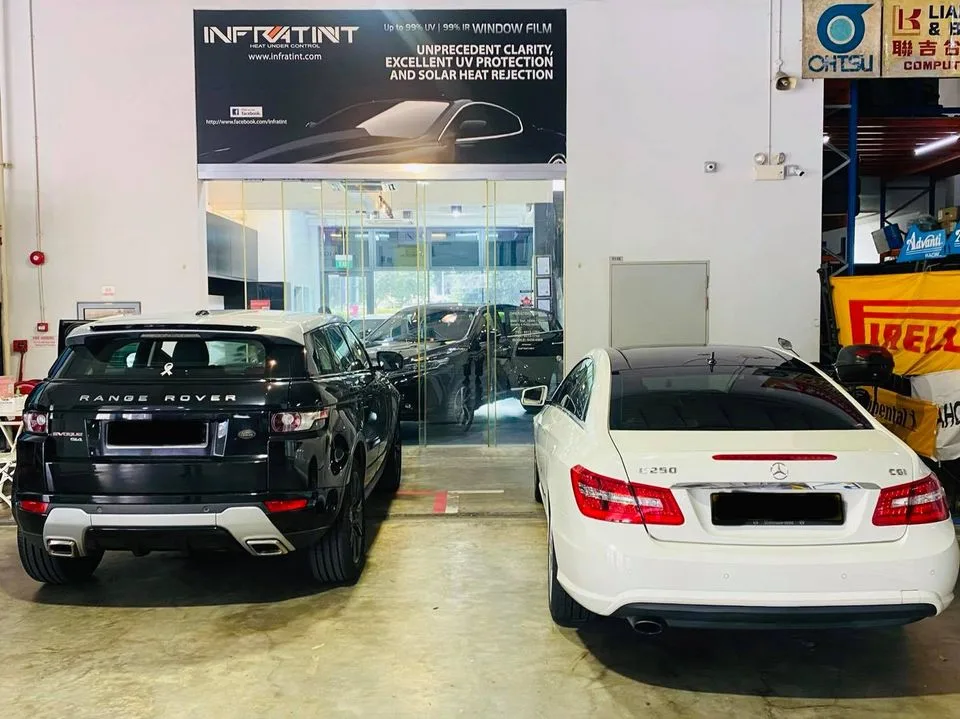Black Range Rover Evoque and white Mercedes-Benz E250 coupe at Infratint Singapore