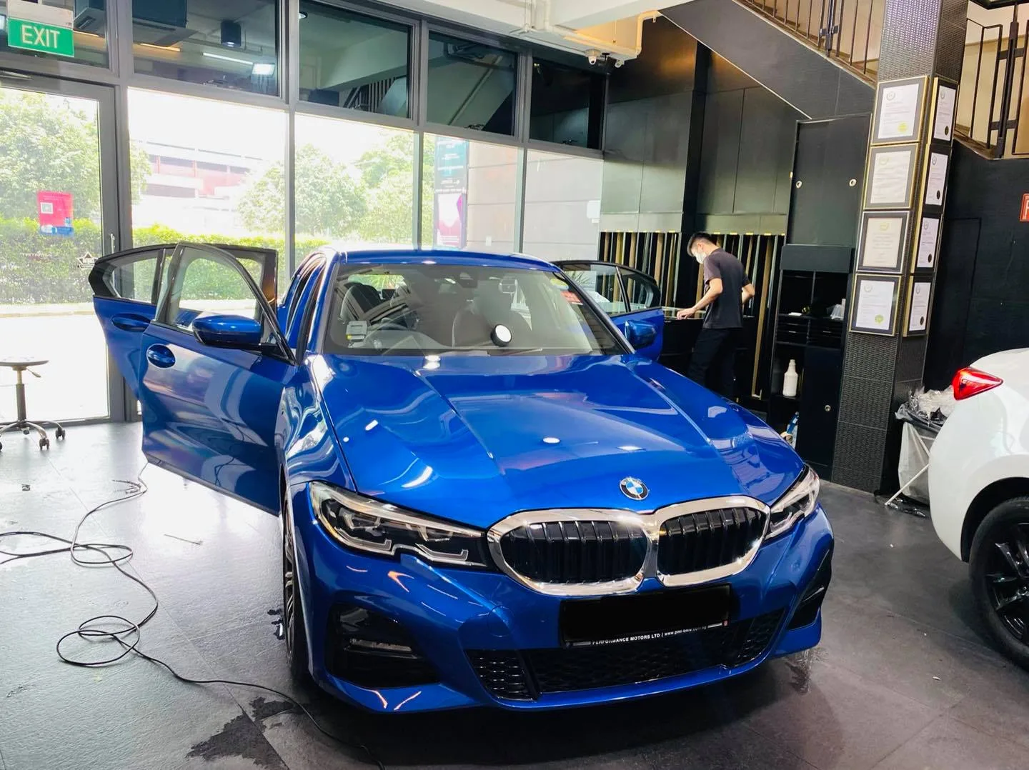 Blue BMW 3 Series sedan being tinted at Infratint Singapore