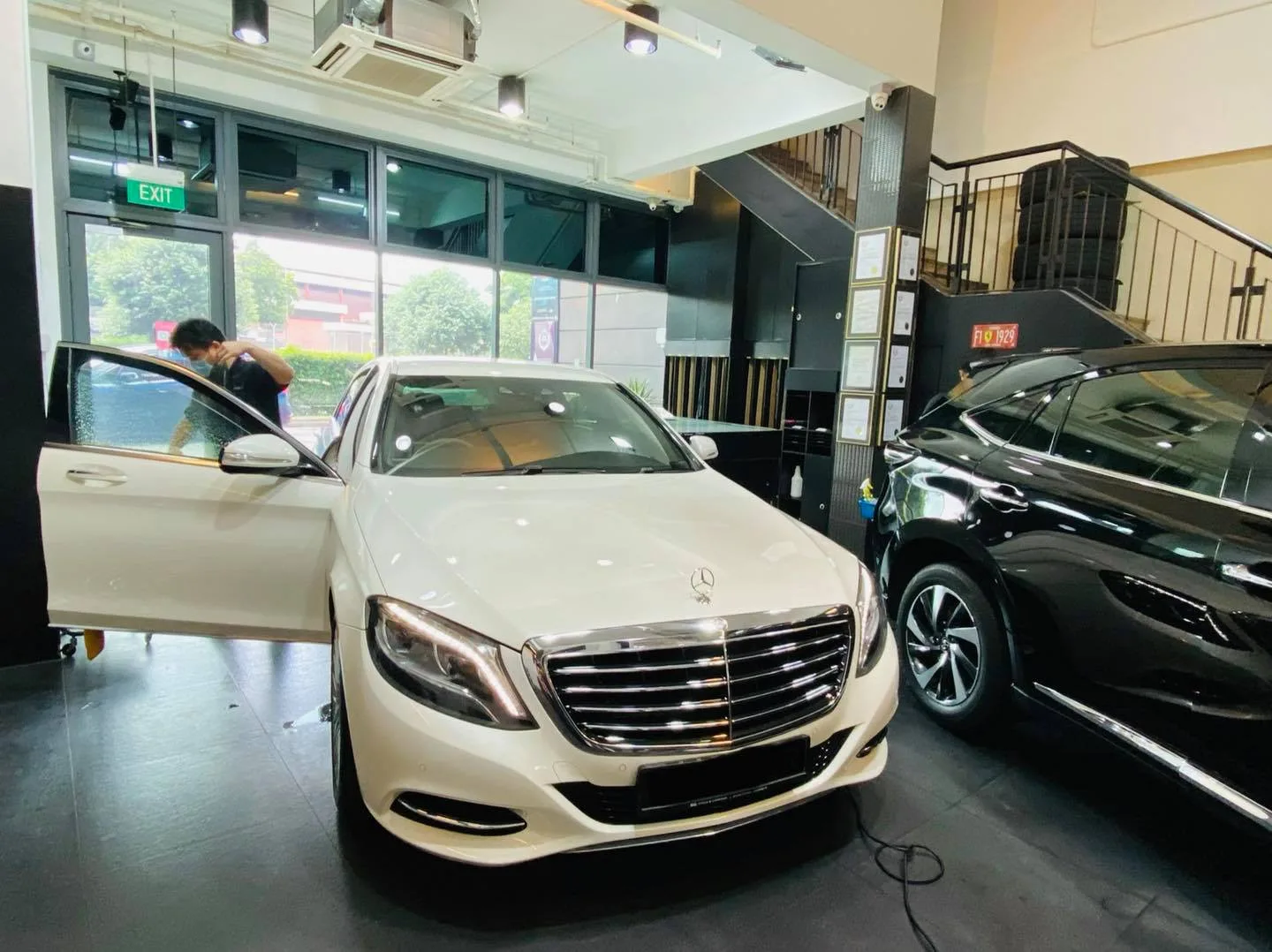 White Mercedes-Benz S-Class with door open beside a black SUV at Infratint Singapore