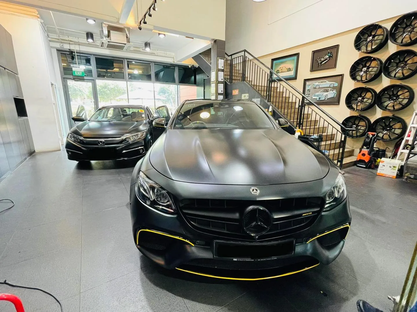 Matte black Mercedes-Benz AMG sedan inside the Infratint Singapore showroom