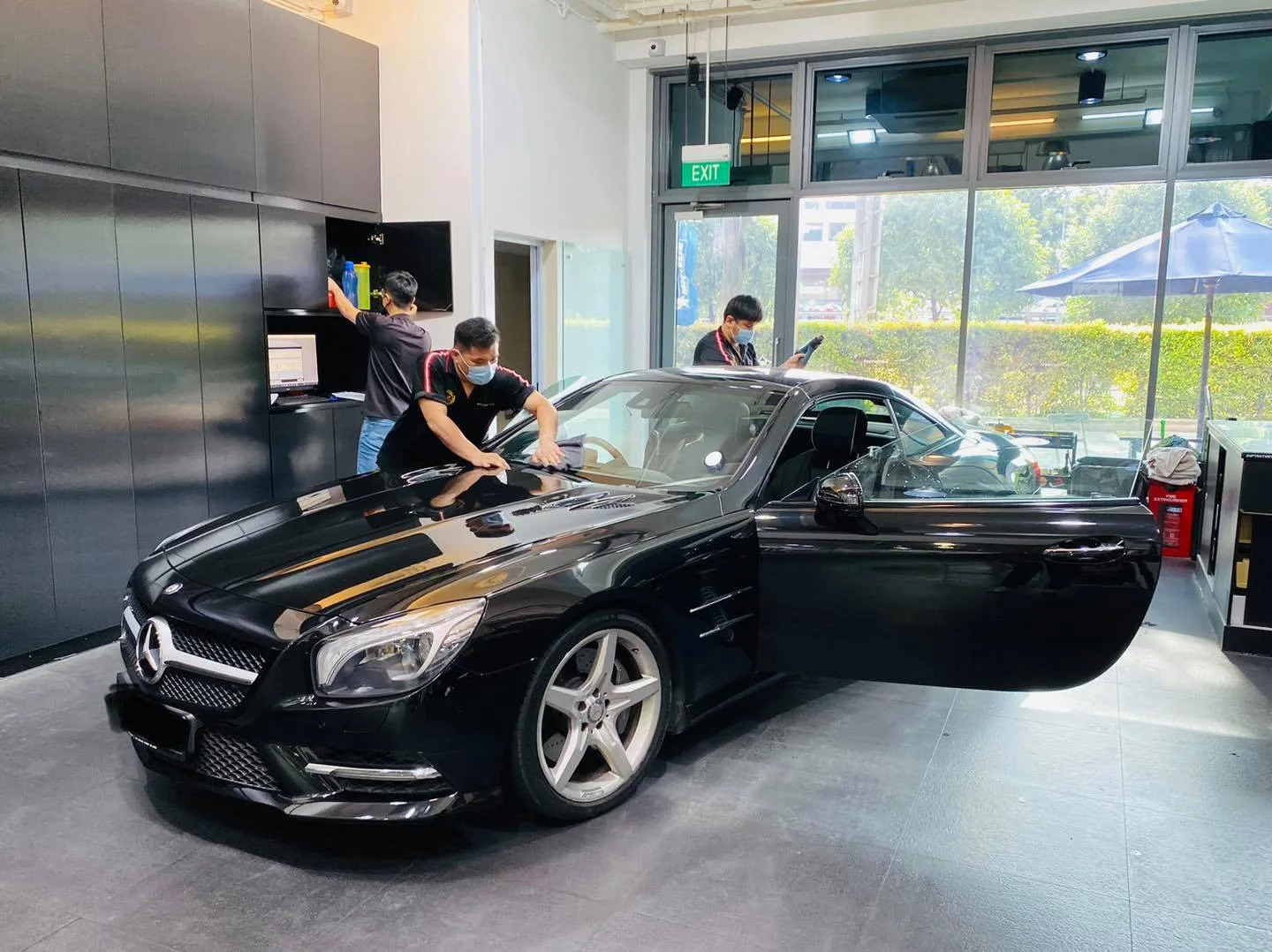 Black Mercedes-Benz SL500 with door open during window tinting at Infratint Singapore
