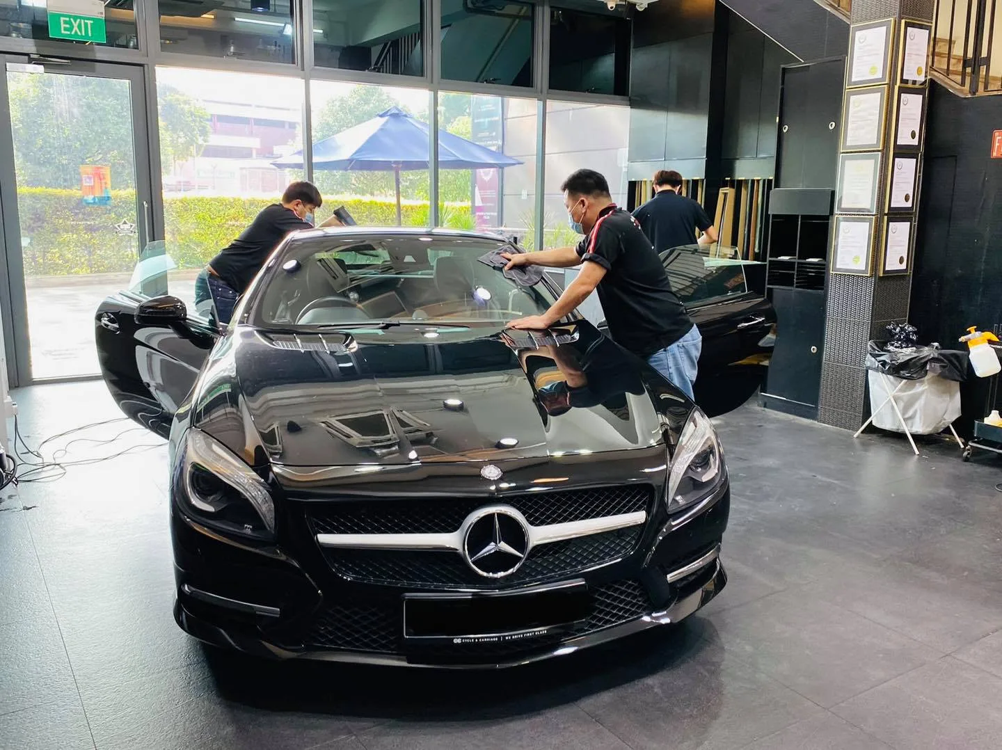 Black Mercedes-Benz SL500 having window film fitted by two installers at Infratint Singapore
