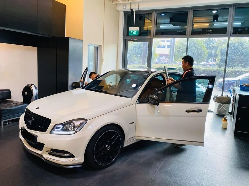 White Mercedes-Benz C-Class W204 with doors open during window tinting at Infratint Singapore