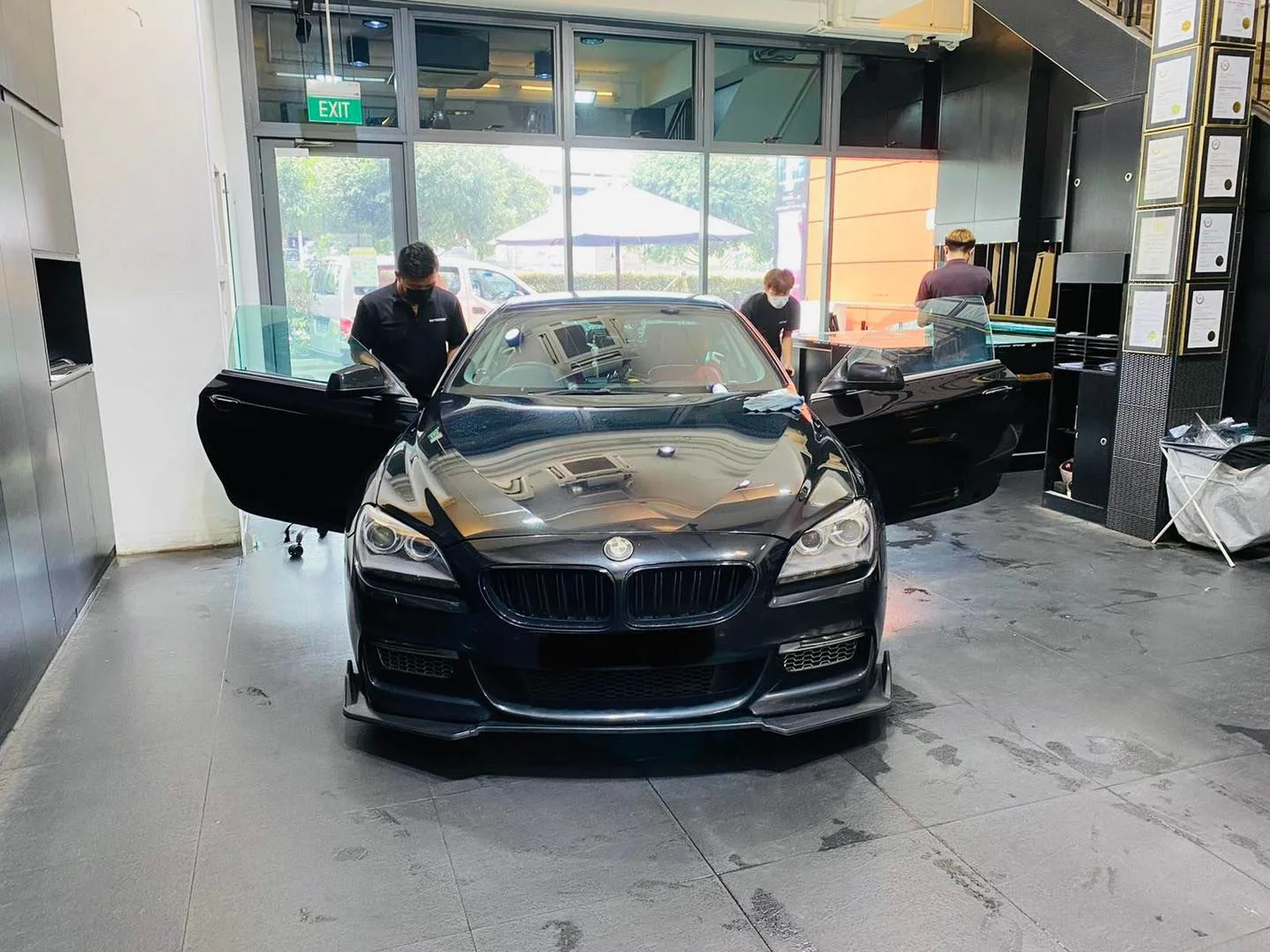 Black BMW 6 Series with doors open during window tinting at Infratint Singapore