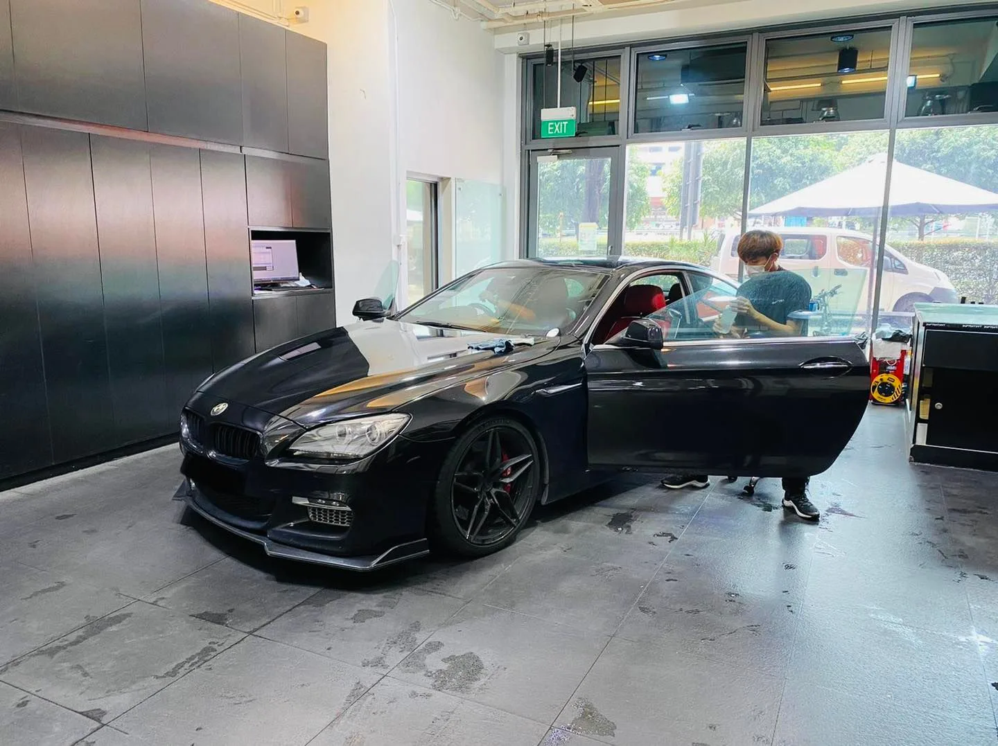 Black BMW 6 Series front three-quarter during window tinting at Infratint Singapore