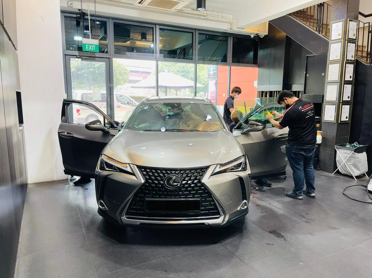 Bronze Lexus UX SUV with doors open during window tinting at Infratint Singapore