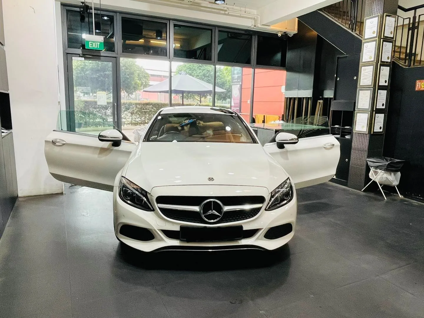 White Mercedes-Benz coupe with doors open before window tinting at Infratint Singapore
