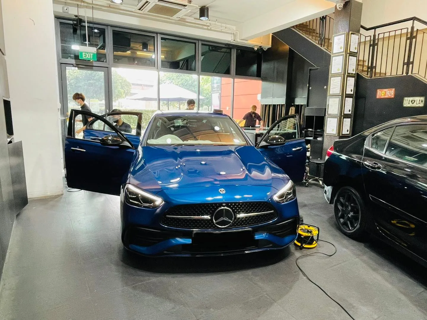 Blue Mercedes-Benz C-Class and dark SUV being tinted at Infratint Singapore