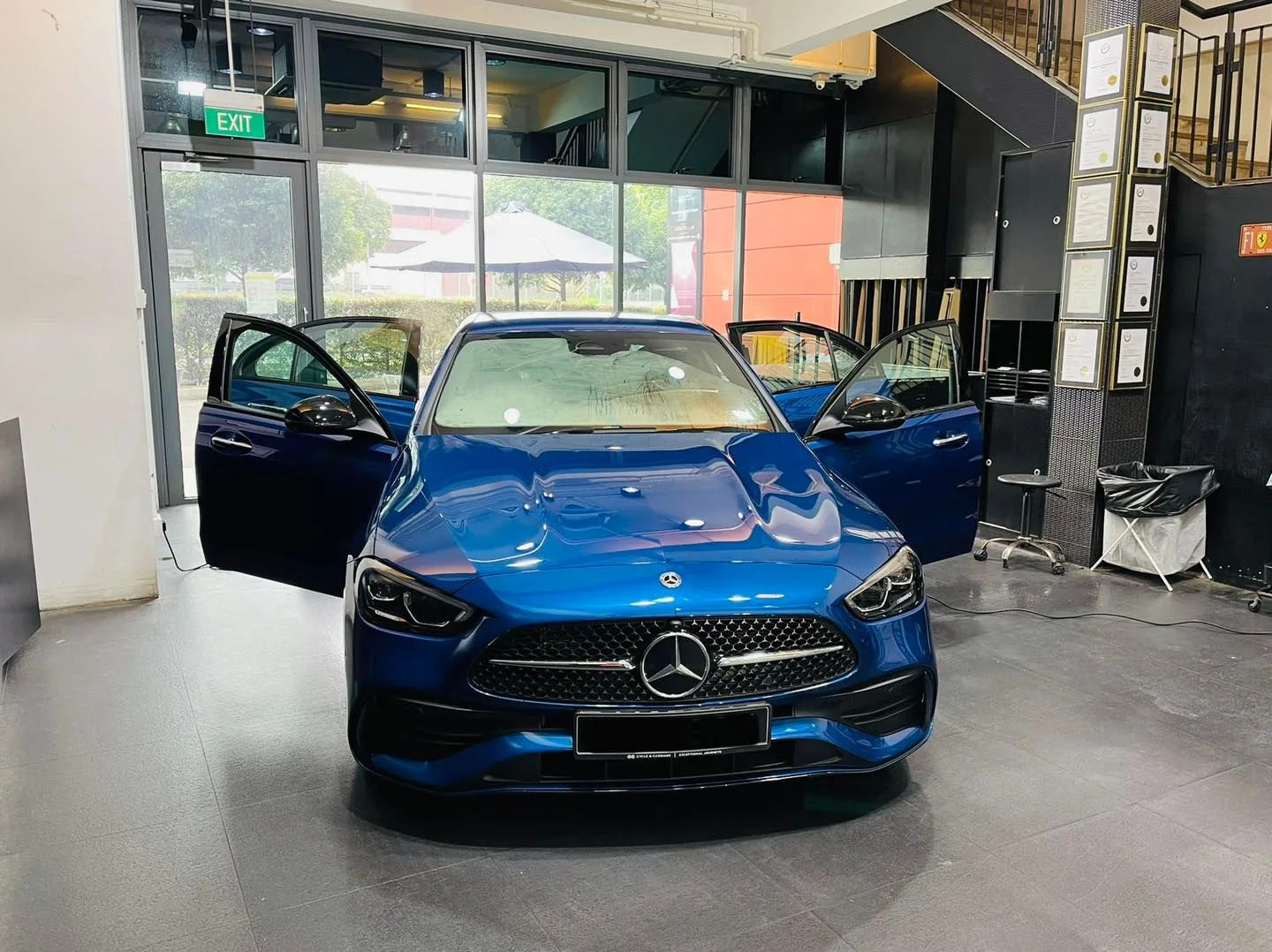Blue Mercedes-Benz C-Class with doors open before window tinting at Infratint Singapore