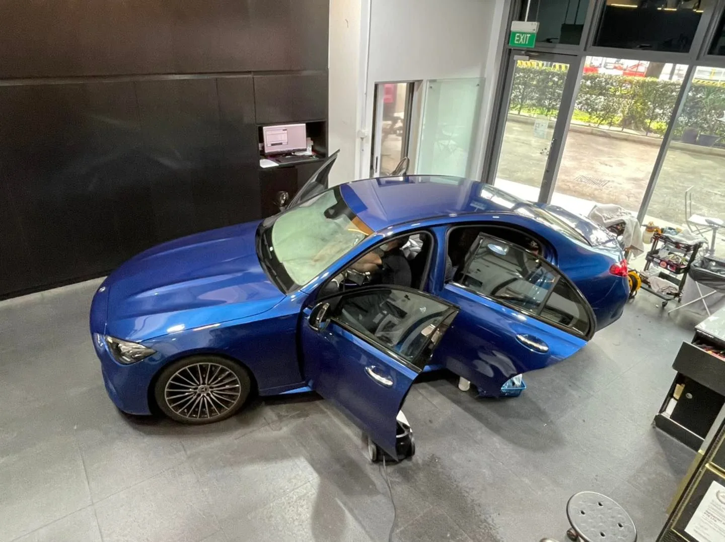 Overhead view of blue Mercedes-Benz C-Class during window tinting at Infratint Singapore