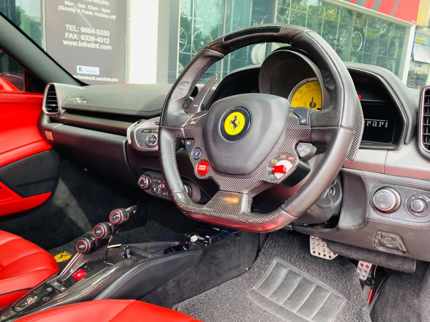 Carbon Ferrari steering wheel and red leather interior at Infratint Singapore