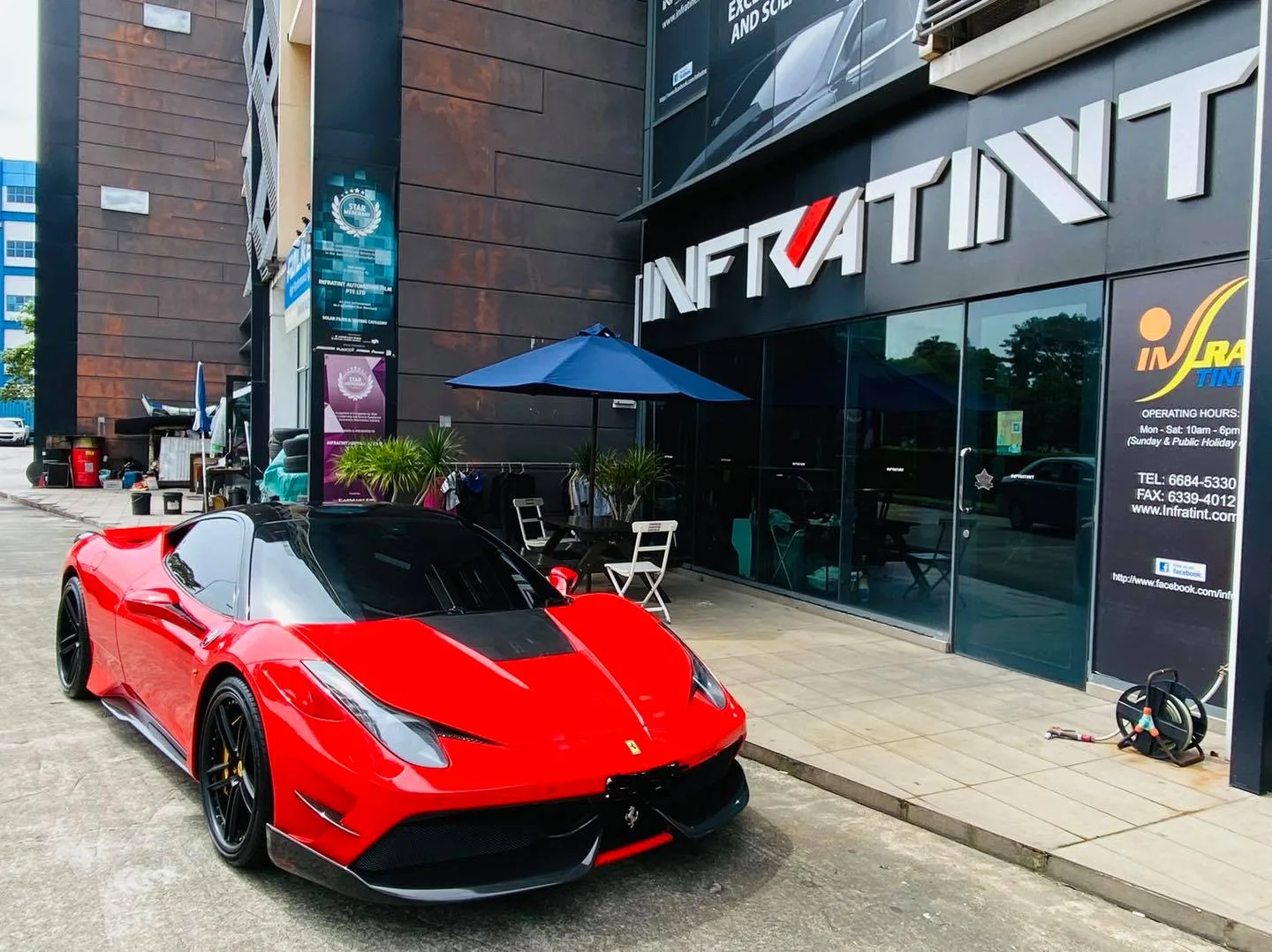 Red Ferrari parked outside Infratint Singapore for window tinting