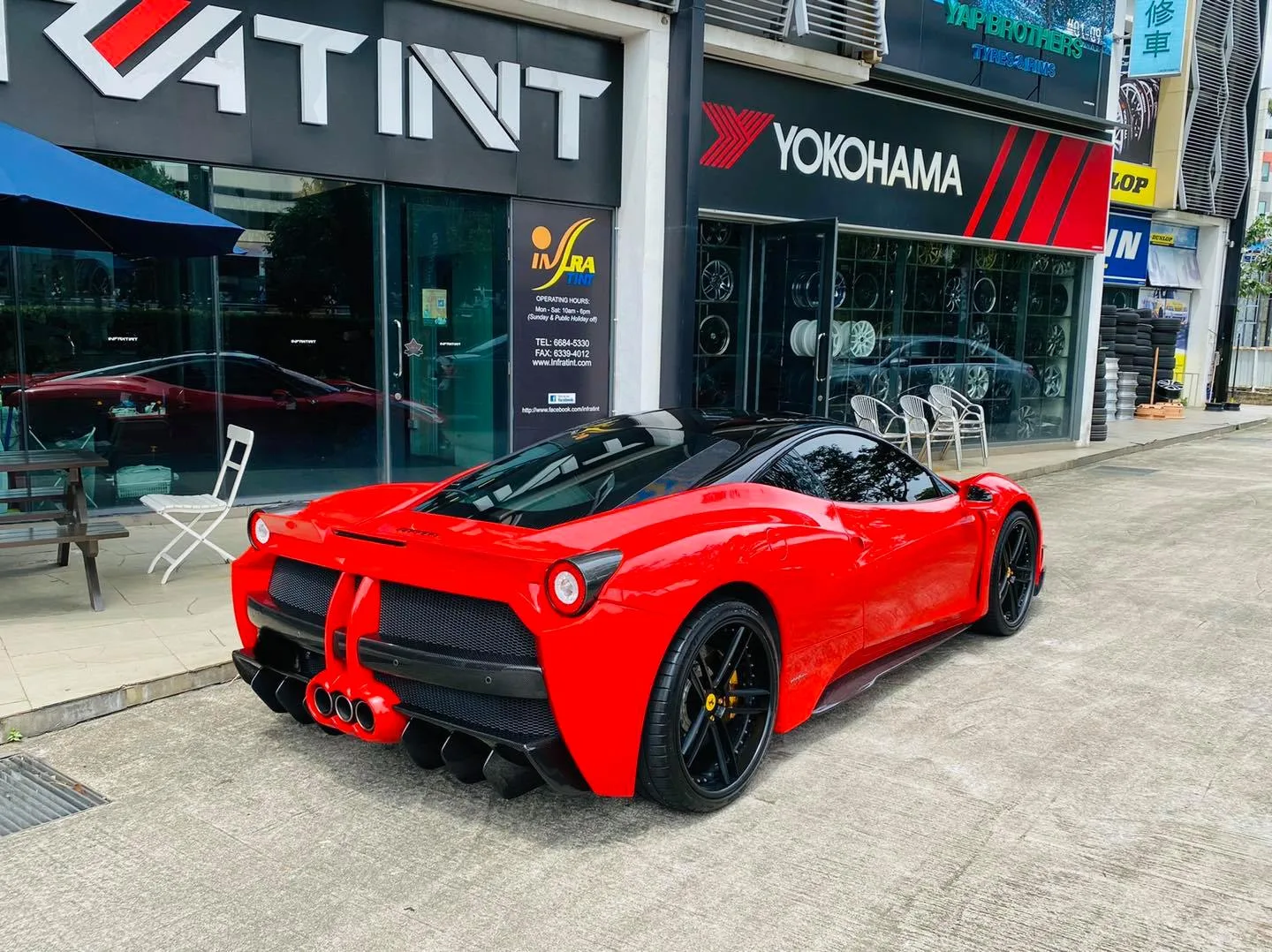 Red Ferrari rear view outside Infratint Singapore