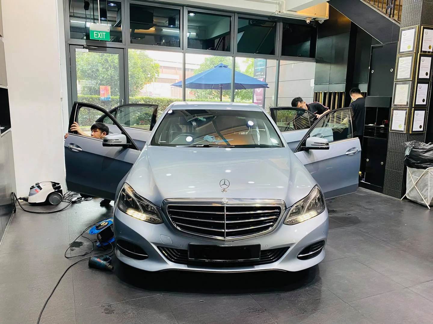 Silver Mercedes-Benz sedan with doors open during window tinting at Infratint Singapore