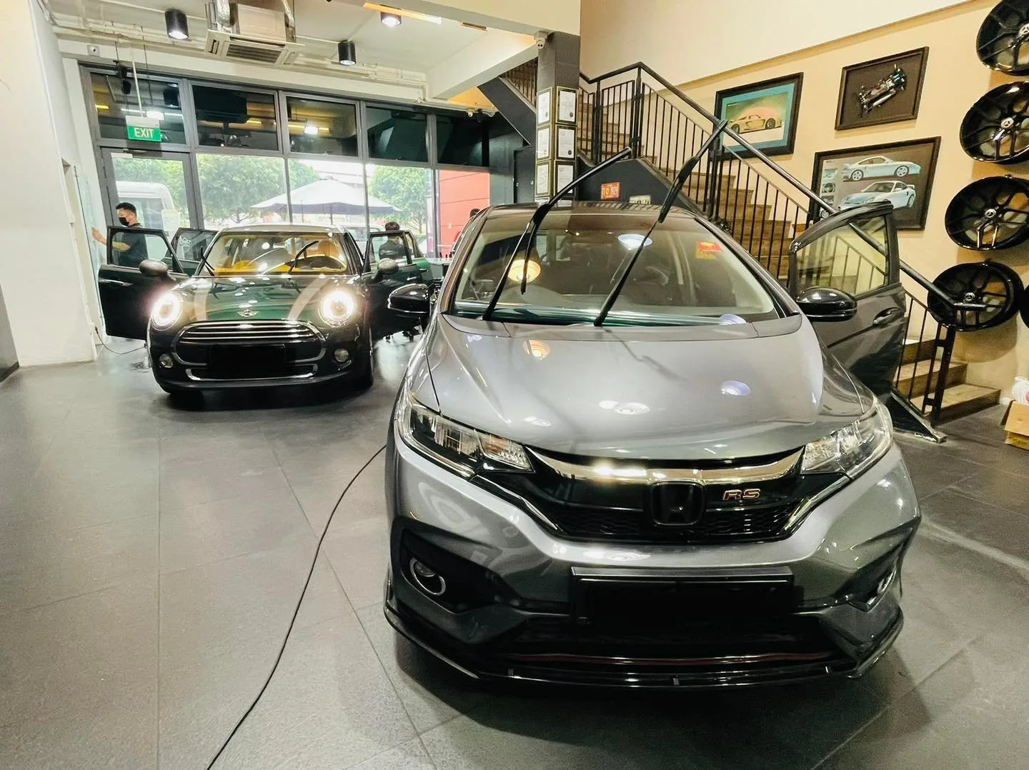 Grey Honda and green Mini Cooper inside Infratint Singapore showroom