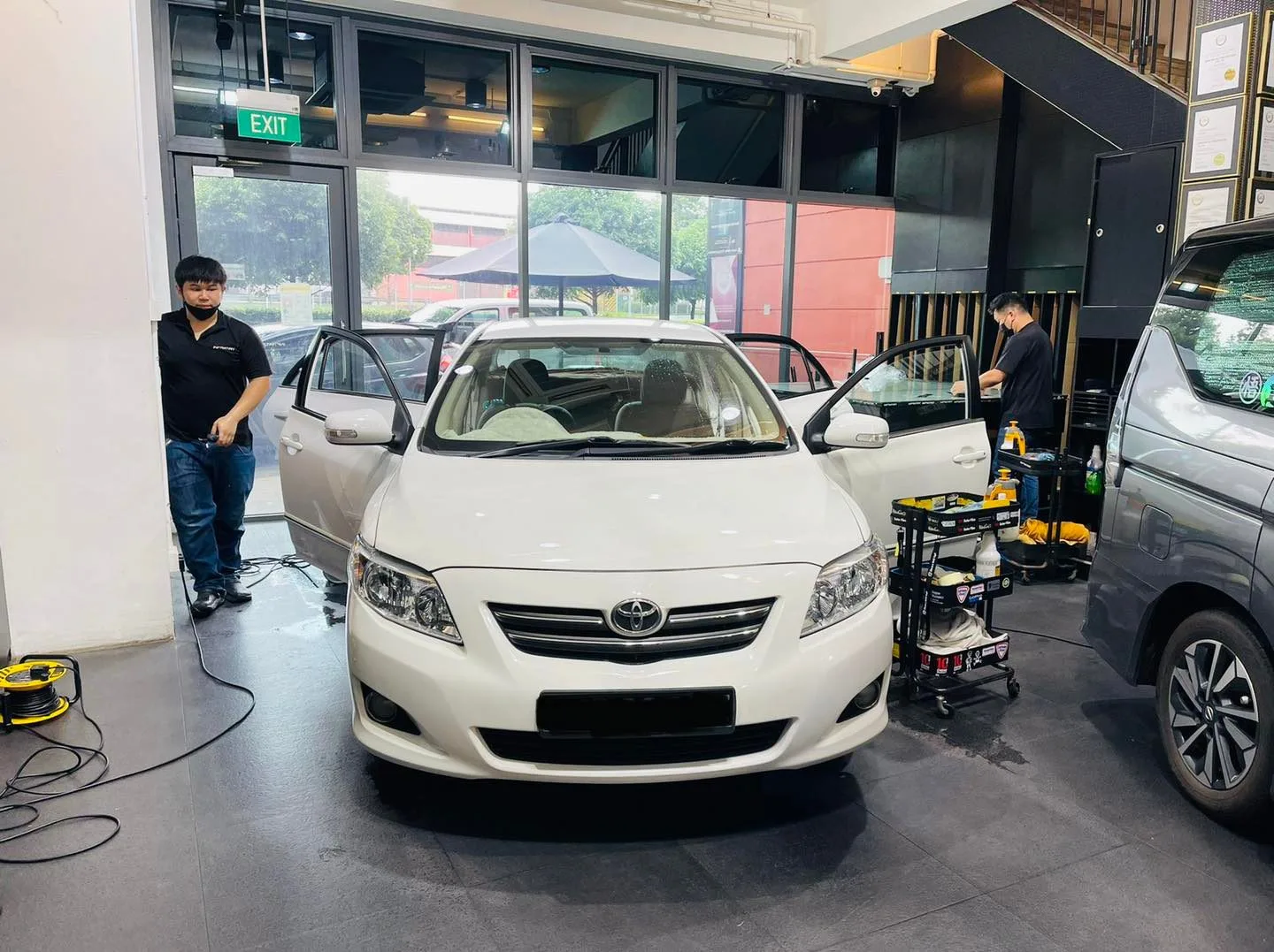 White Toyota sedan having its windows tinted at Infratint Singapore