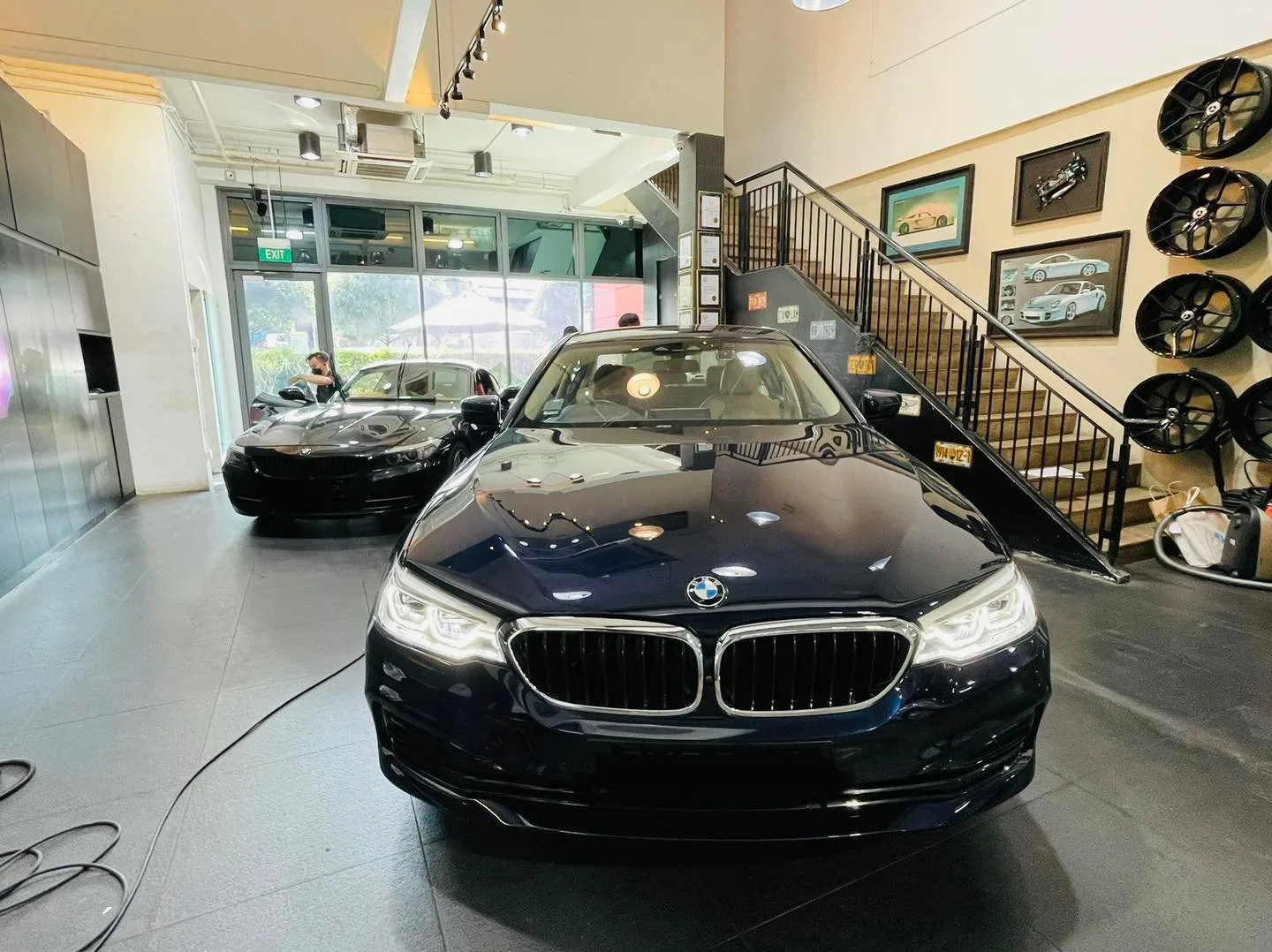 Dark blue BMW sedan in the Infratint Singapore showroom for window tinting