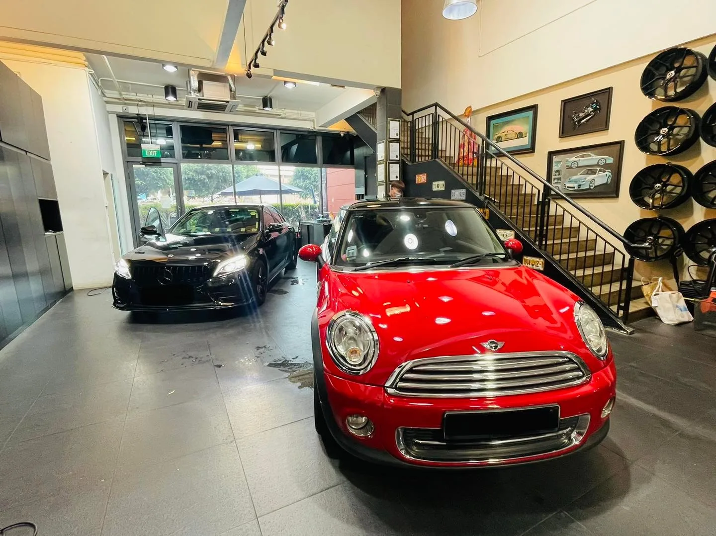 Red Mini Cooper and black BMW sedan inside the Infratint Singapore showroom for window tinting