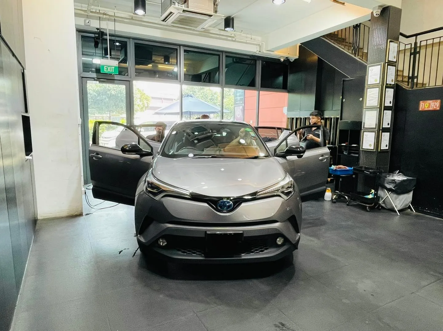 Silver Toyota C-HR crossover with doors open during window tinting at Infratint Singapore