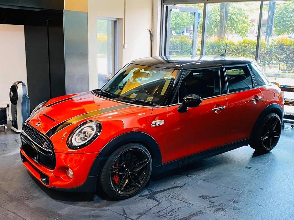 Orange Mini Cooper S side view with freshly tinted windows at Infratint Singapore