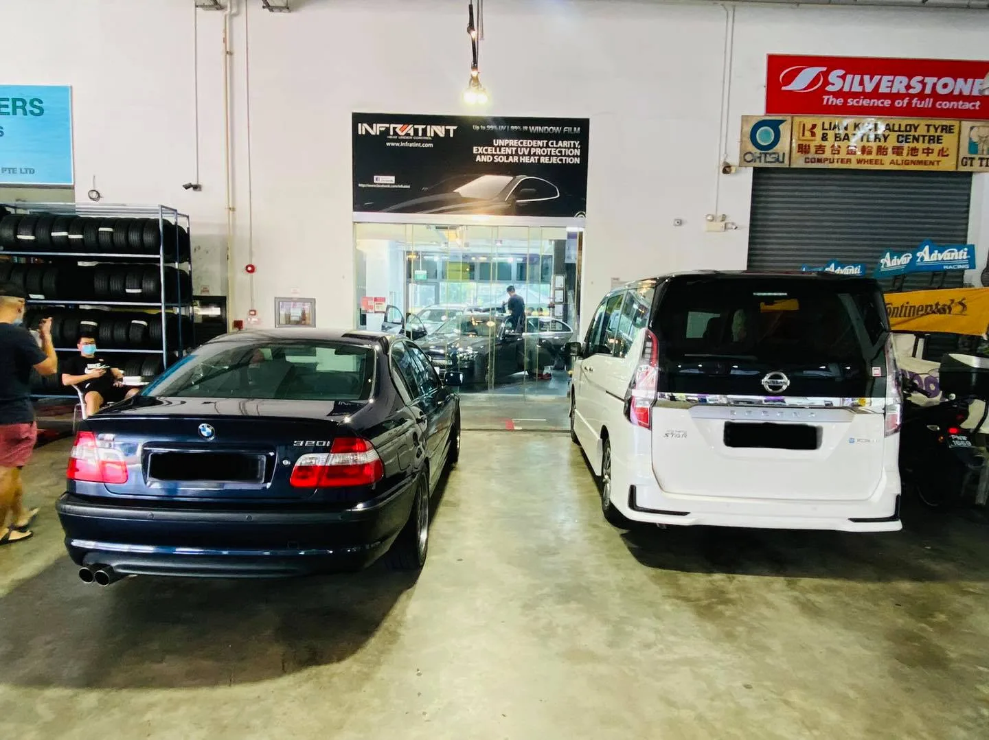 Black BMW 320i and white Nissan Serena waiting at Infratint Singapore