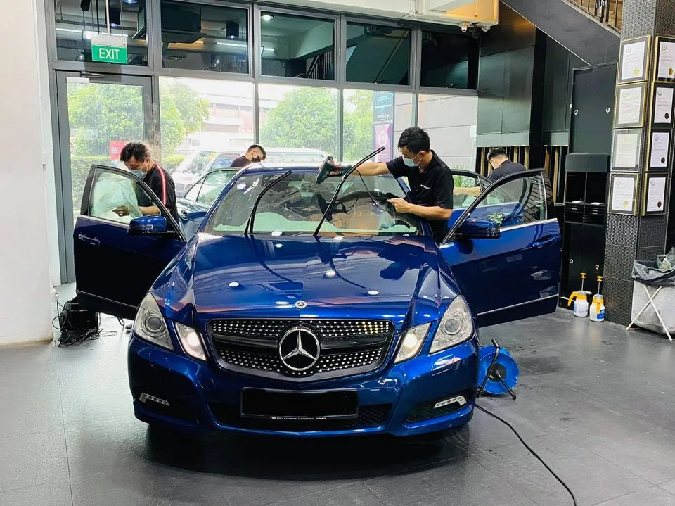 Blue Mercedes-Benz E-Class getting windscreen film fitted at Infratint Singapore
