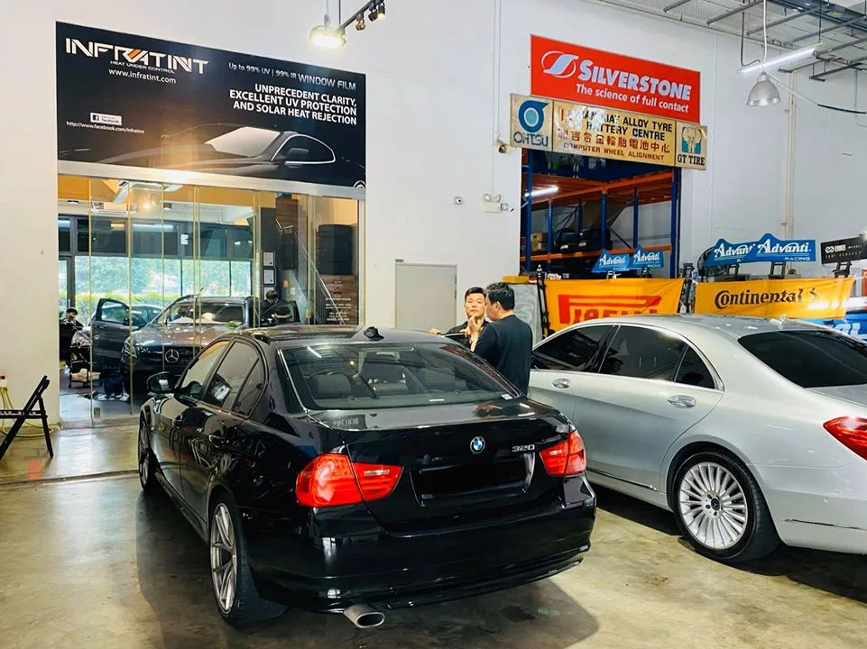Black BMW 3 Series and silver Mercedes-Benz S-Class in the install bay at Infratint Singapore
