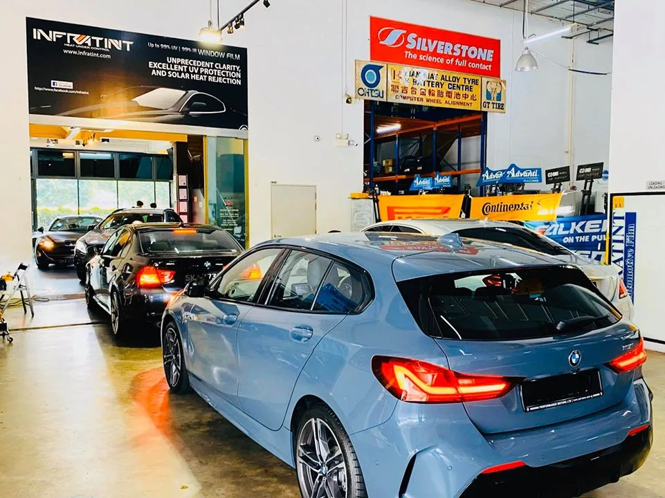 Rear of a blue-grey BMW 1 Series with a black BMW coupe behind it at Infratint Singapore