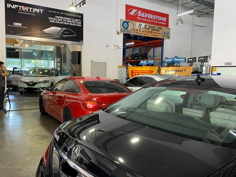 Red BMW coupe, black Mercedes-Benz and white Renault at Infratint Singapore for window film
