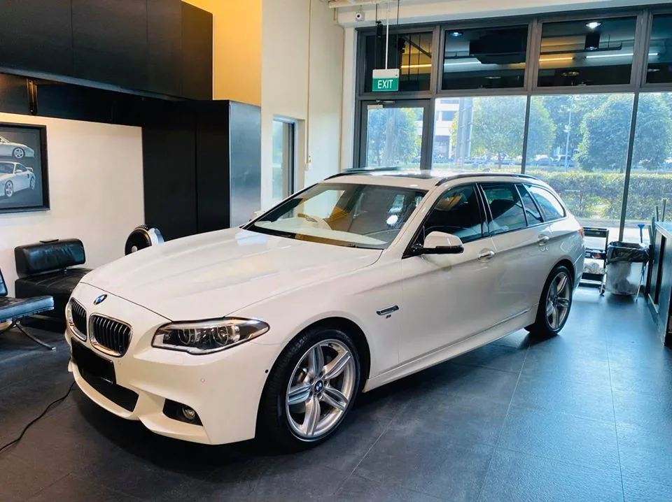 White BMW 5 Series Touring wagon side profile at Infratint Singapore