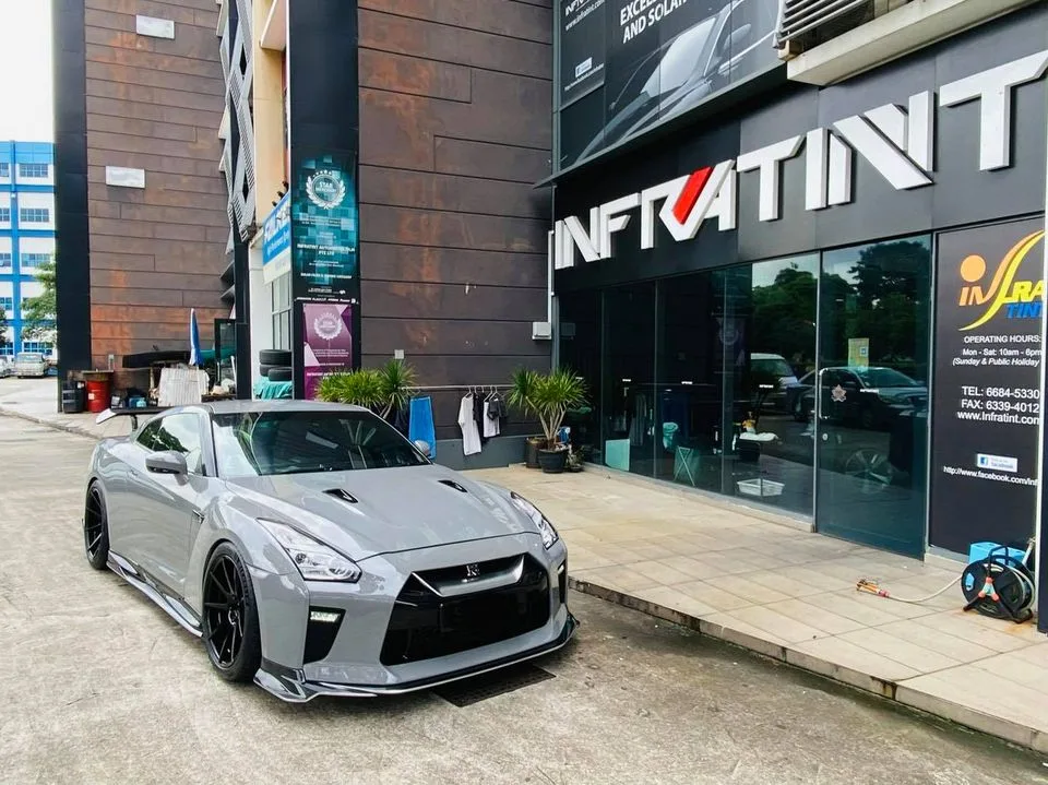Grey Nissan GT-R parked outside the Infratint Singapore shopfront