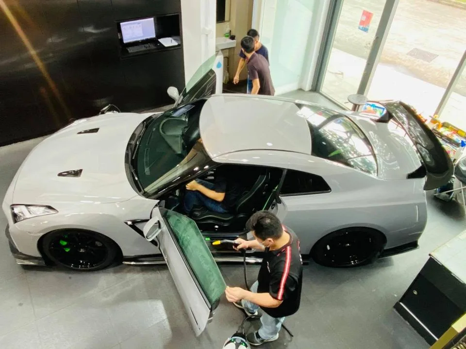 Overhead view of a grey Nissan GT-R being tinted at Infratint Singapore