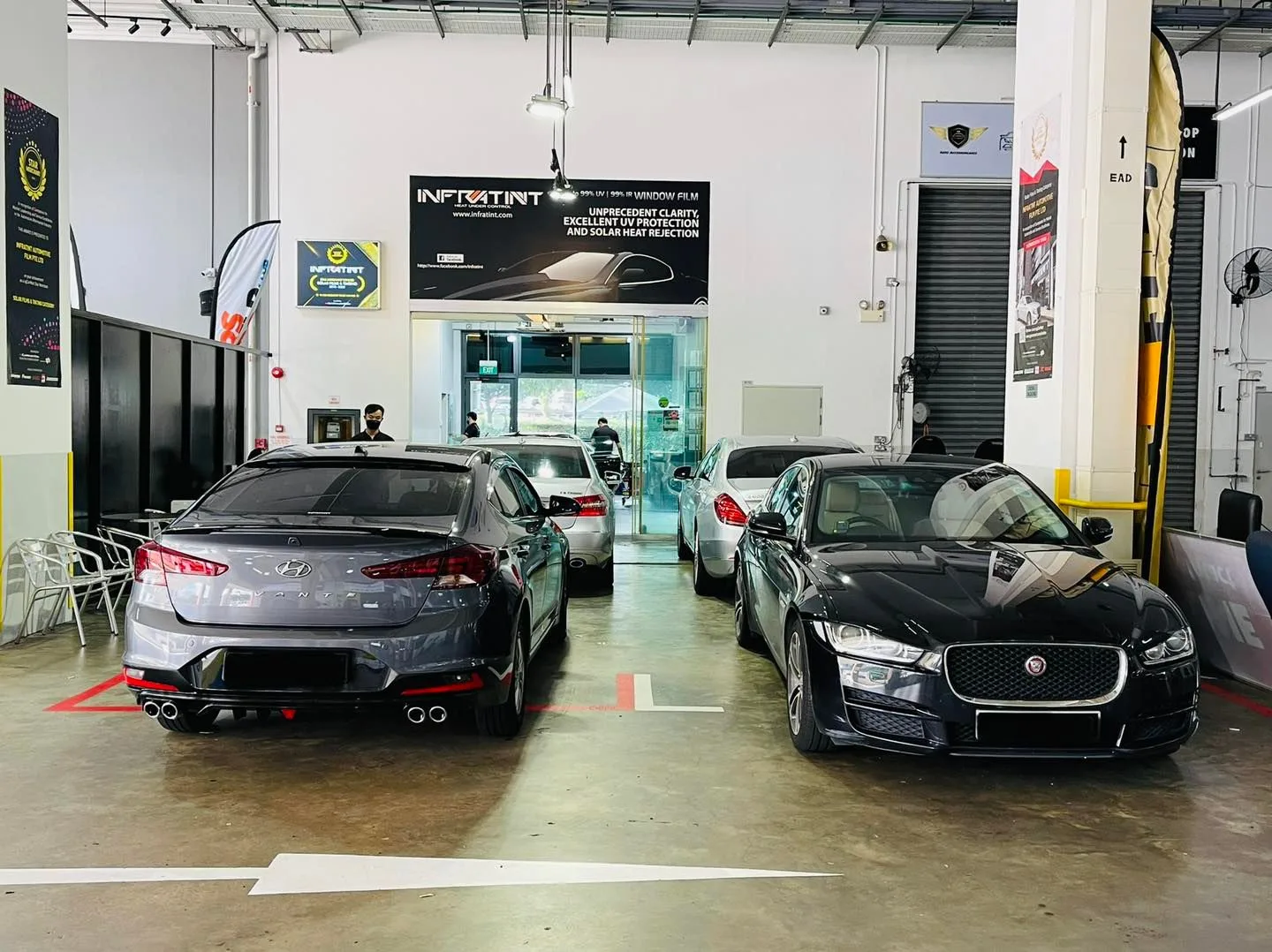 Grey sedan and black Jaguar parked at Infratint Singapore for window tinting