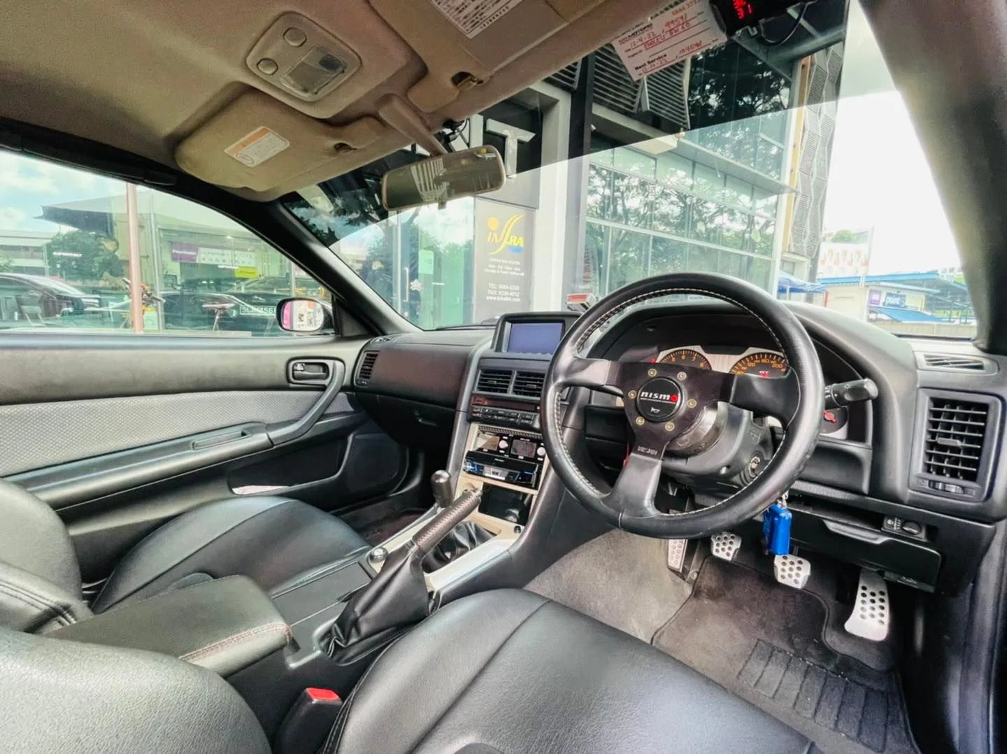 Right-hand-drive interior of a Nissan GT-R R34 at Infratint Singapore