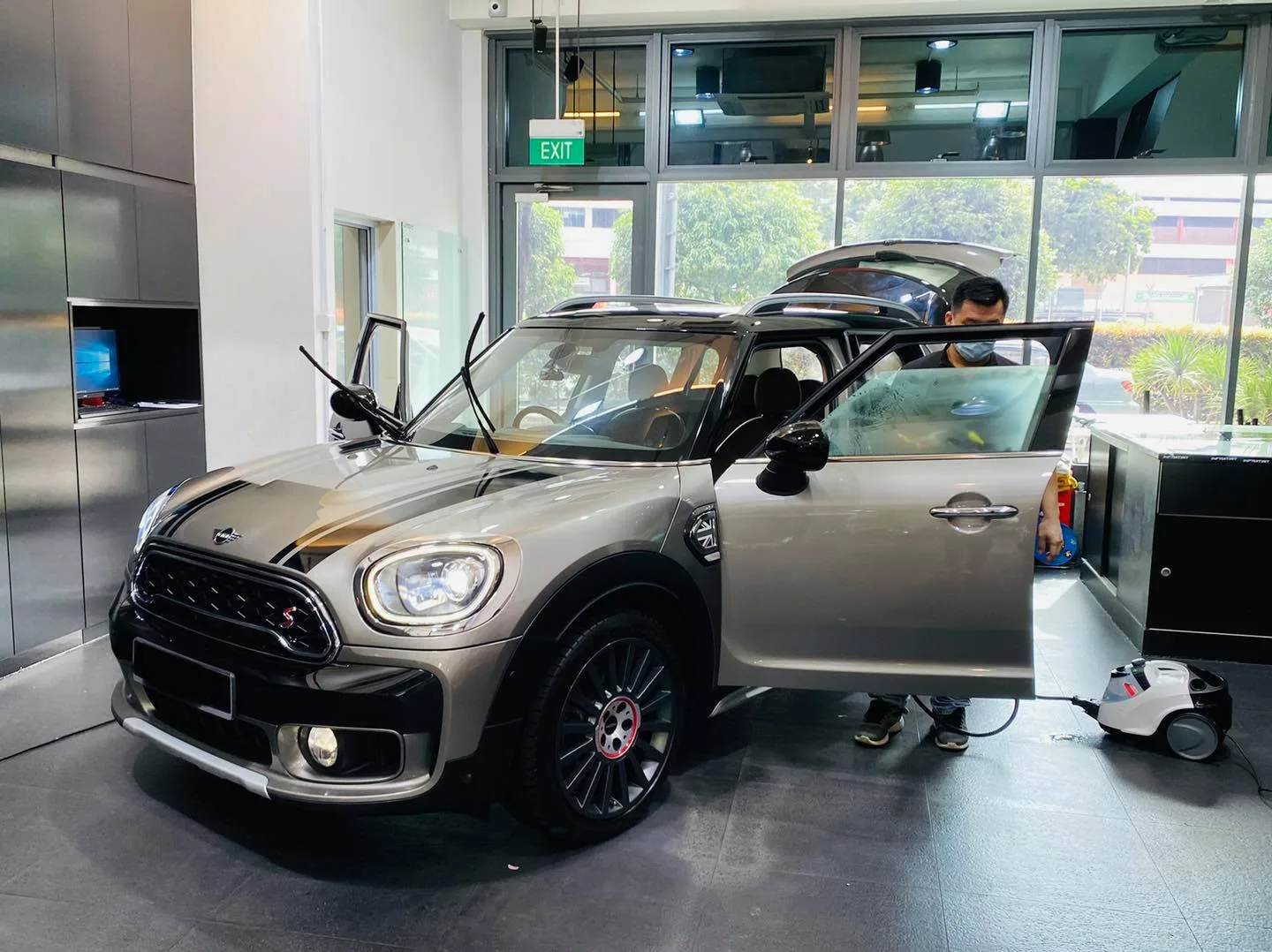 Grey Mini Countryman with doors open during window tinting at Infratint Singapore