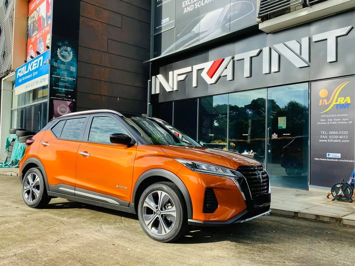 Orange Nissan Kicks e-Power parked outside Infratint Singapore for window tinting