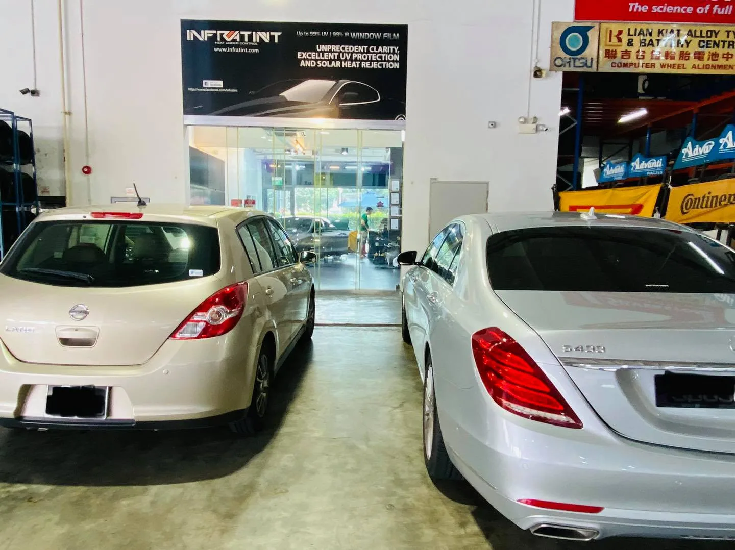Champagne Nissan Latio and silver Mercedes-Benz S400 parked at Infratint Singapore