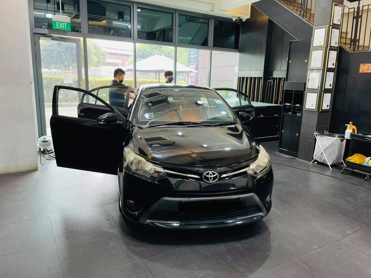 Black Toyota sedan front view with open door at Infratint Singapore